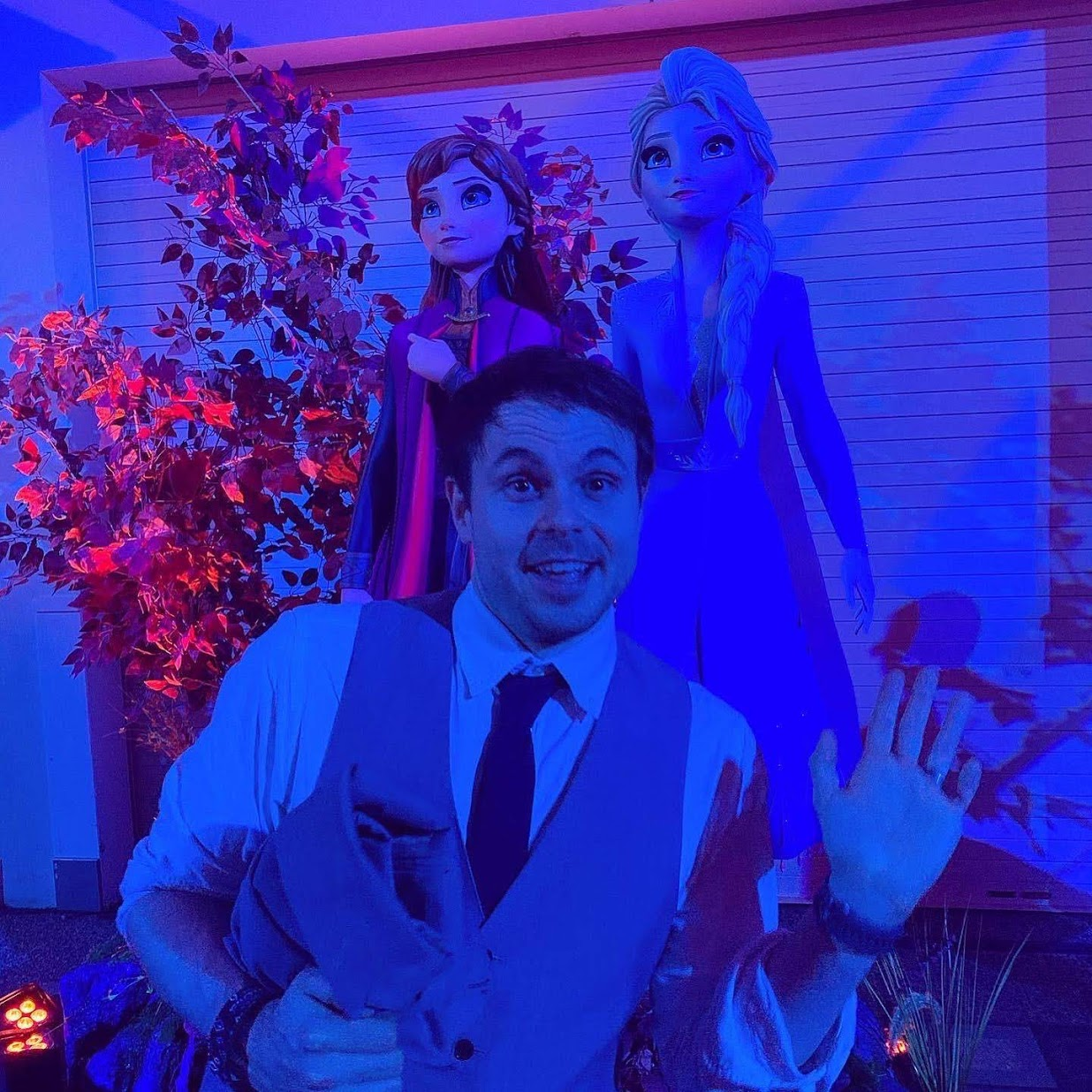 A picture of Paul in front of a statue of Elsa and Anna from the Frozen movie